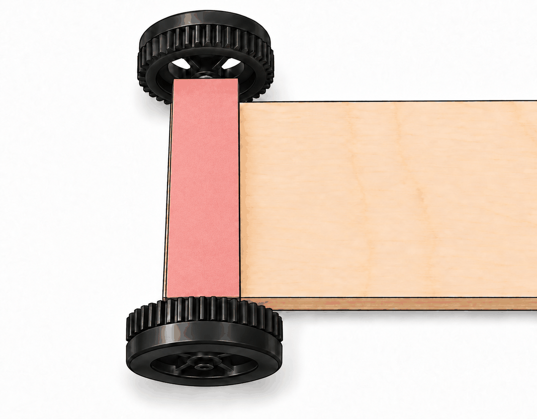 Bottom of the car with the axle holder covered by a strip of paper and the wheels on both sides