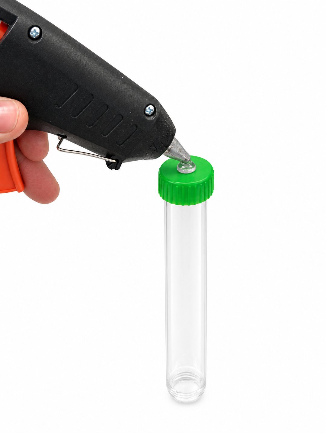 Hot glue gun putting a drop of glue on the flat top of the green cap, with the test tube held upright below it